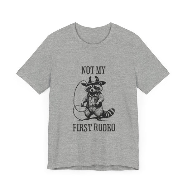 Not My First Rodeo Cowboy Raccoon Shirt, Funny Western Graphic Cotton Tee, Cute Quirky Country Style T-Shirt for Rodeo Fans & Animal Lovers